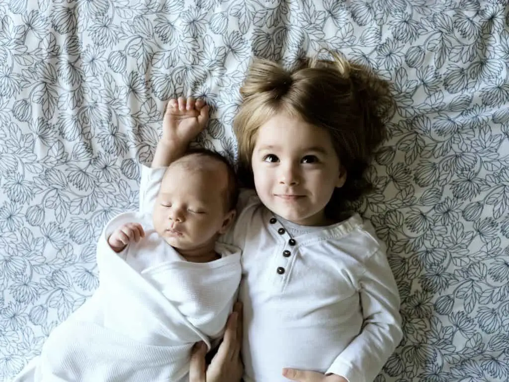 two under two laying in bed