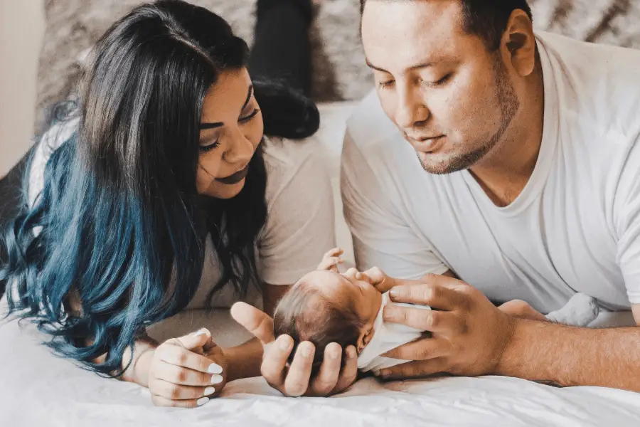 mom and dad at home with newborn baby