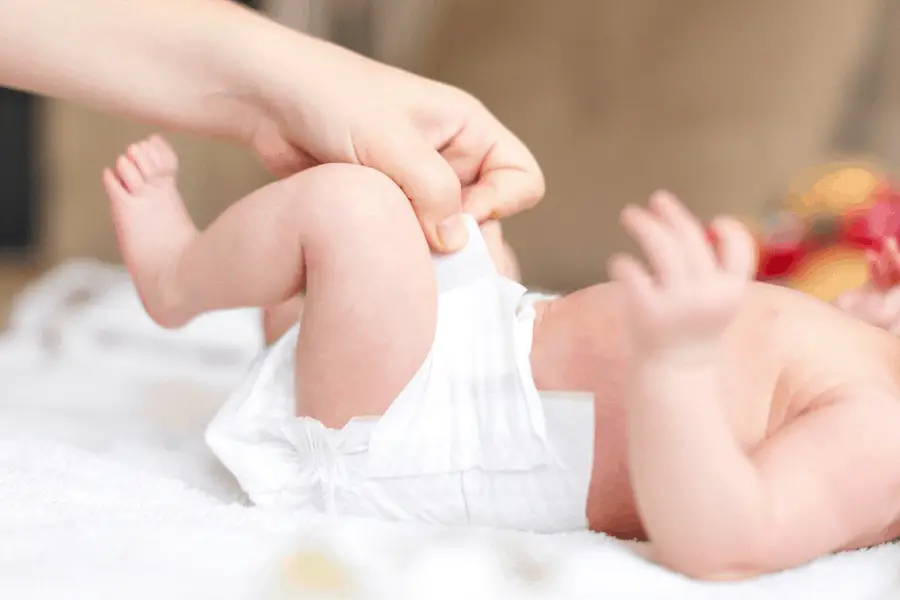 new mom changing babys diaper