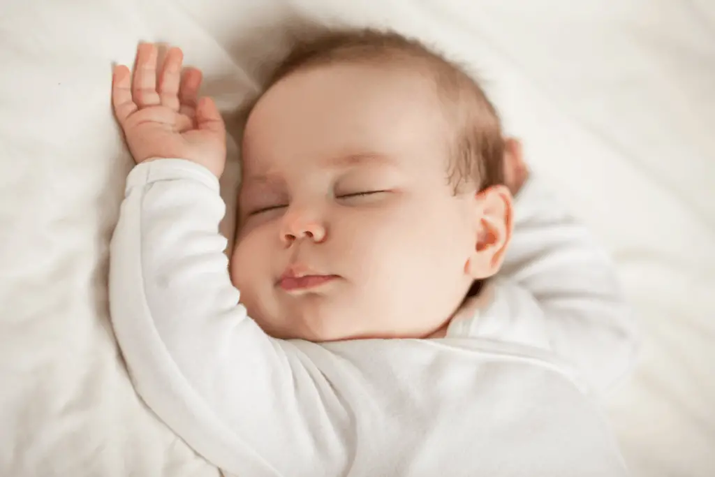 newborn baby dressed with a sleeping bag for sleep in winter