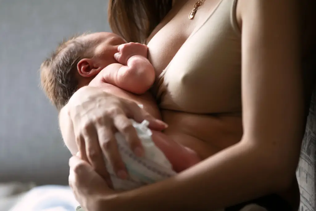 mom breastfeeding her newborn baby wearing a comfortable nursing bra