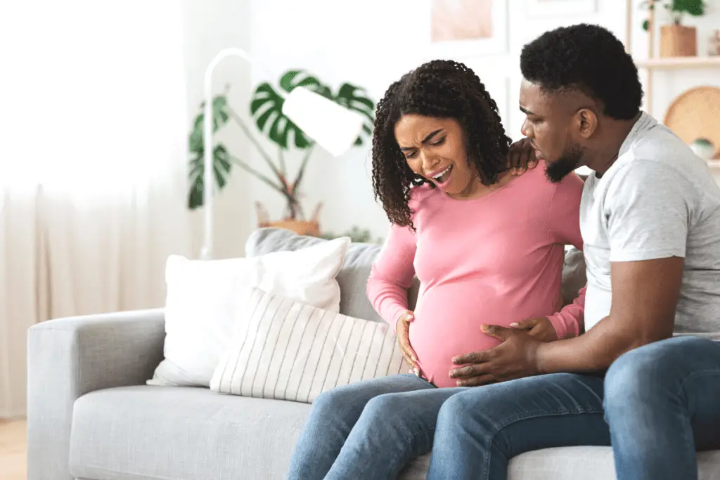 pregnant woman in labor with her partner using positive birth affirmations to keep a positive mindset