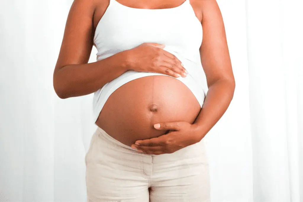 pregnant woman holding her belly