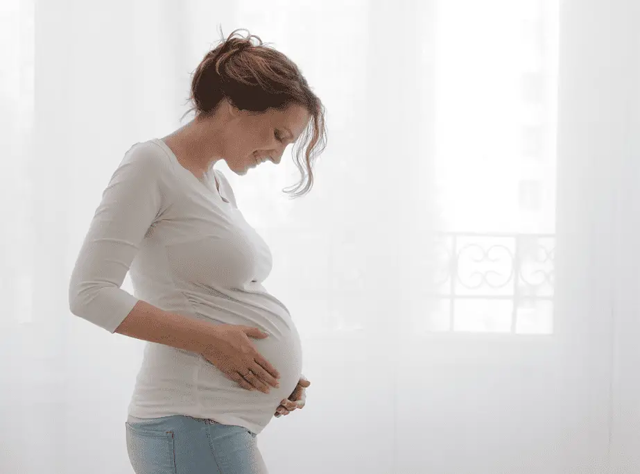 pregnant woman trying to induce her labor naturally at home